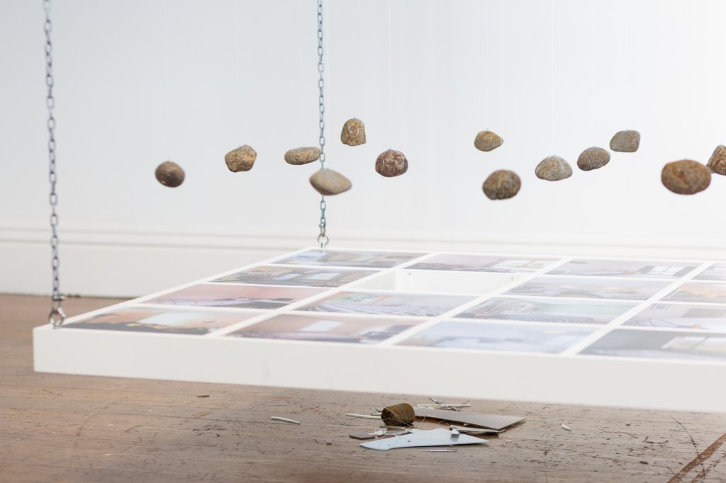 Image of a rock that has dropped through Lost Bedrooms installation by Jonny Scholes.